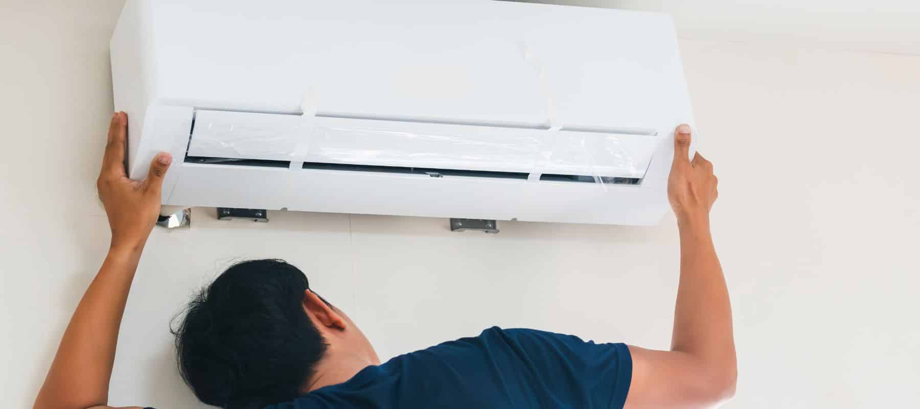 ac technician performing an inspection on a ductless ac unit