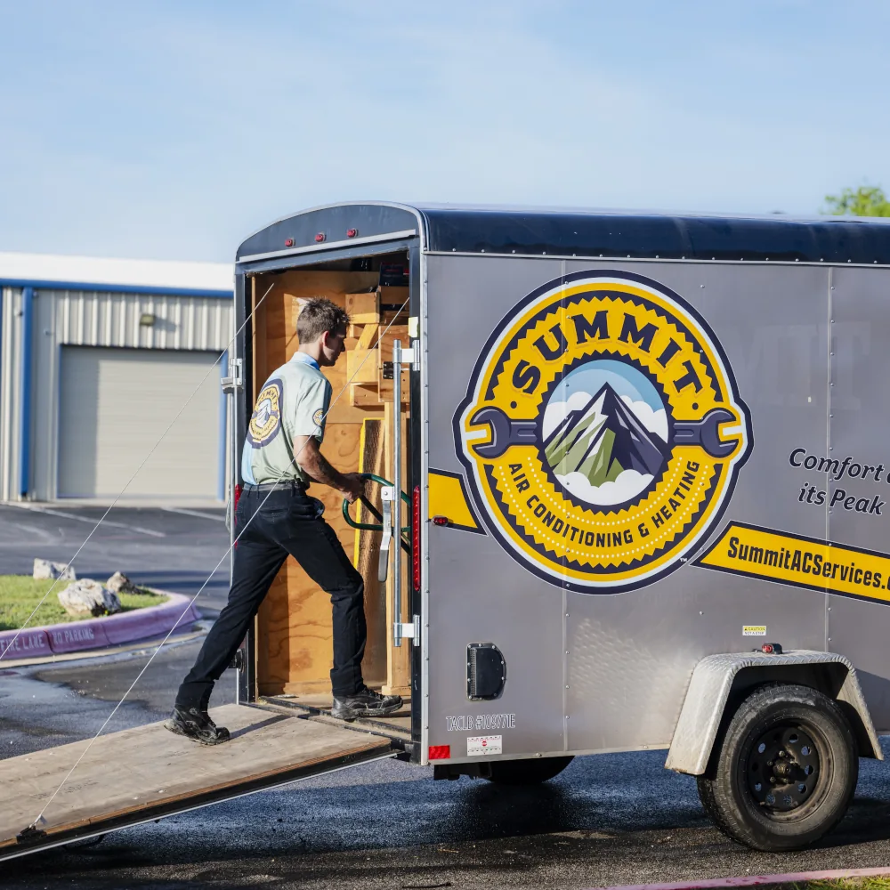 Summit AC team member loading equipment into a vehicle
