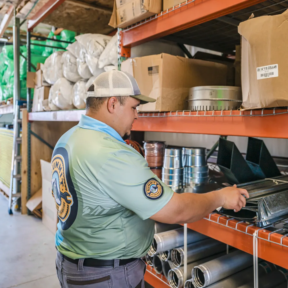 Summit AC crew member inspecting a part