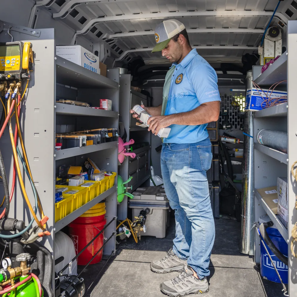 Summit AC team member inspecting a part