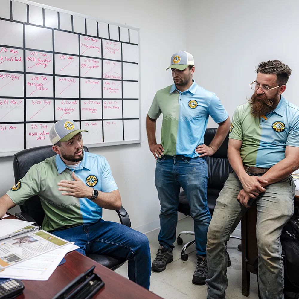 3 Summit AC crew members talking inside an office
