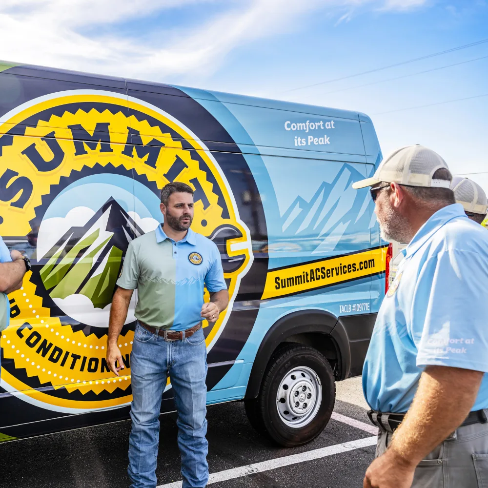Summit AC team talking with a company van on the back
