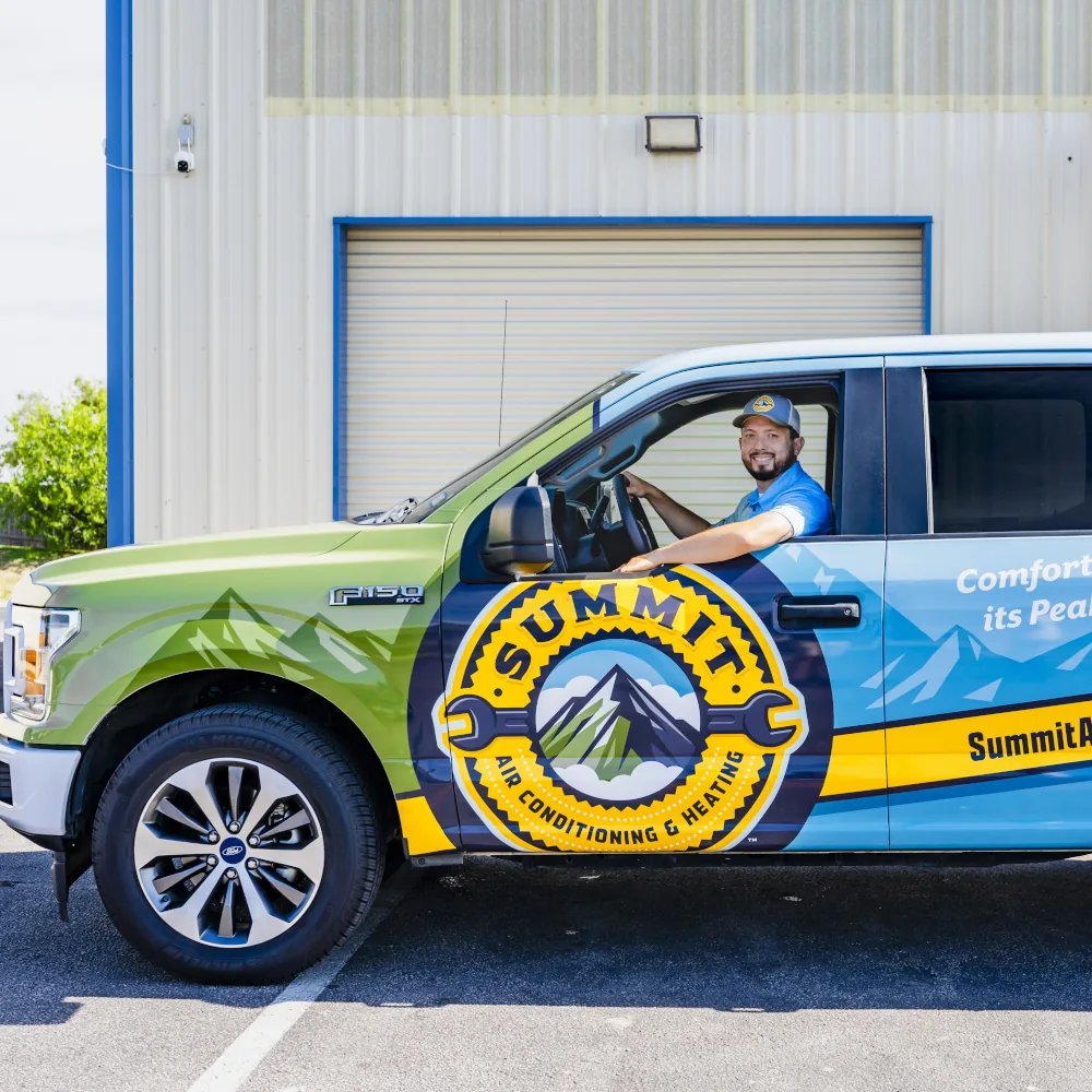 Summit AC team member in a company truck