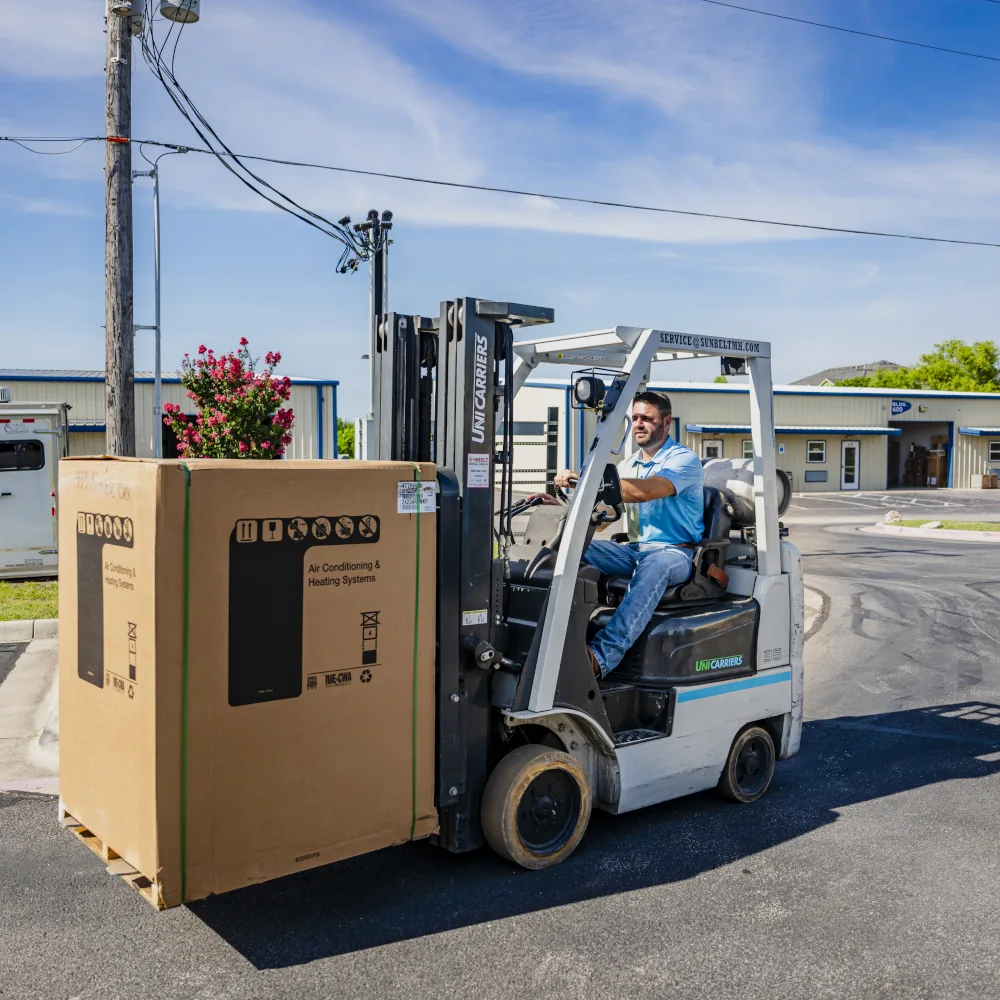 Summit AC crew member transporting an HVAC unit