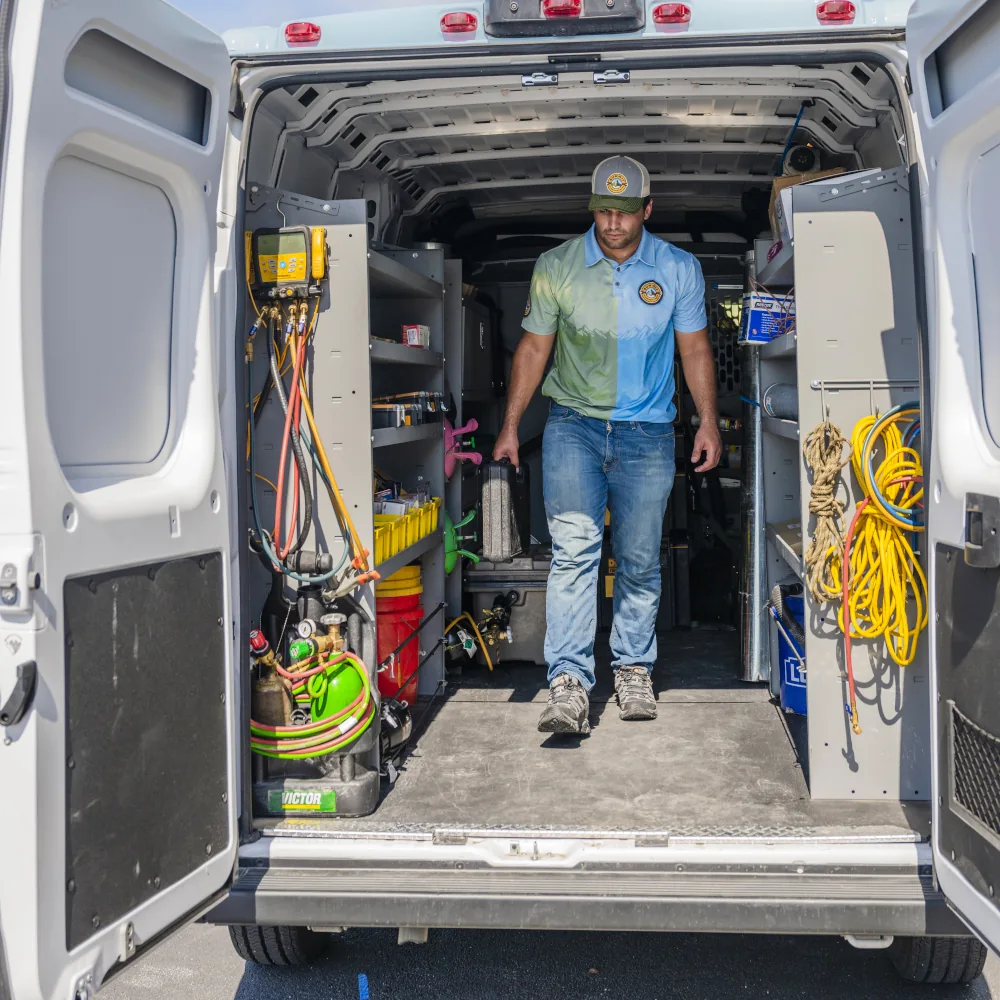 Summit Air Conditioning & Heating crew member walking out of a van