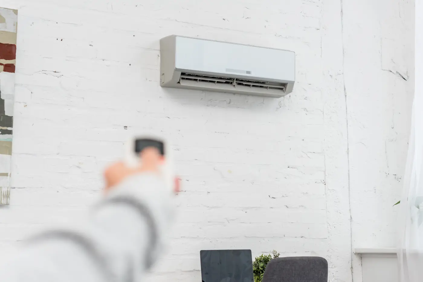 Person controlling an AC unit using a remote