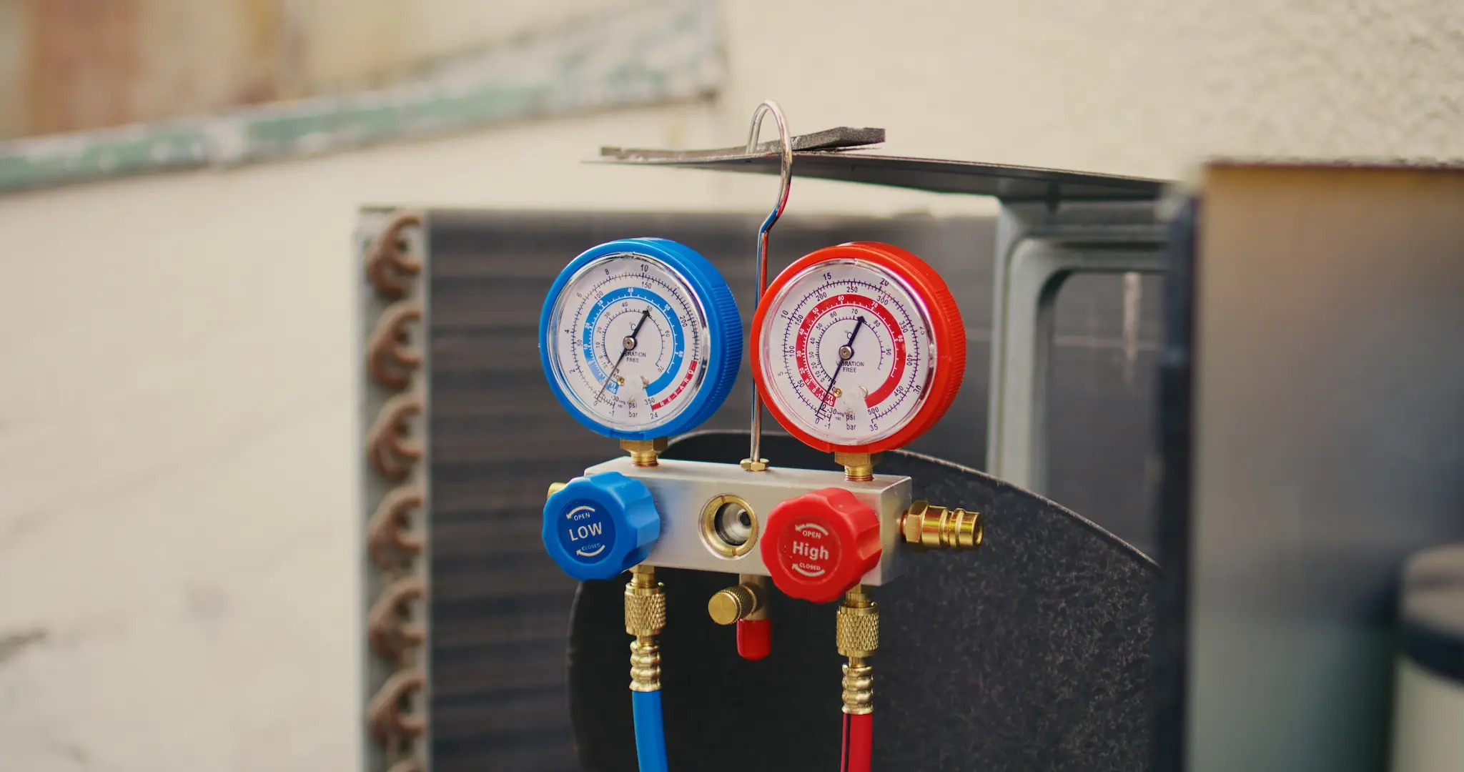 Checking refrigerant levels on an AC unit with a manifold gauge